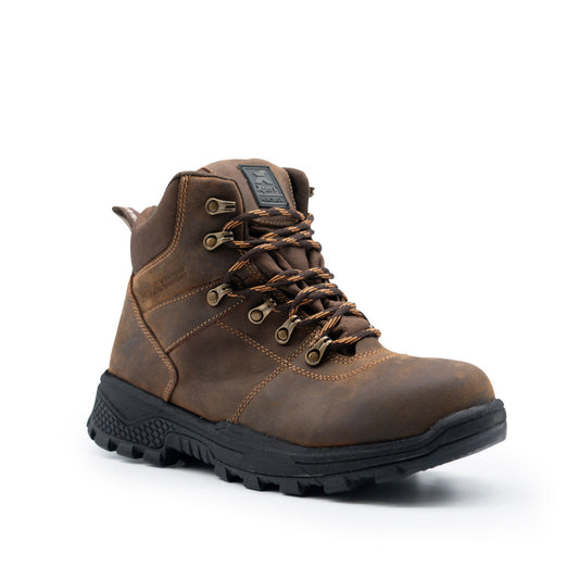 The Xpert Heritage Explorer Waterproof Hiking Boot by Cottonmount, featuring a brown leather design, thick black rubber slip-resistant outsole, metal eyelets, and laces, is positioned at an angle against a white background.