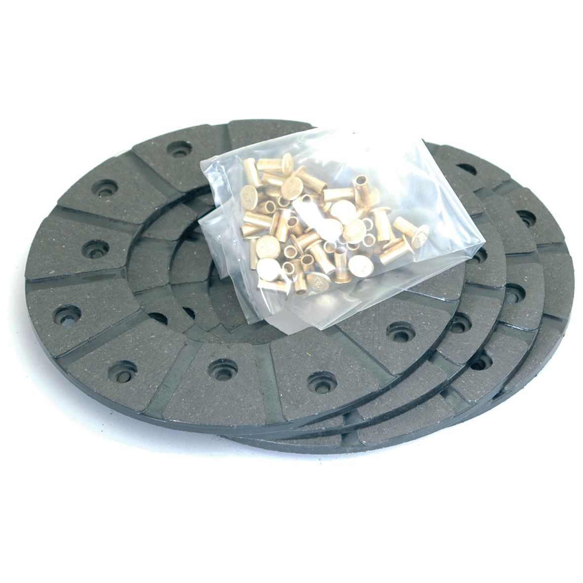 Three gray circular gaskets from the Brake Lining Kit Disc, OD 165mm (Sparex Part No. S.58621) stacked on top of each other with a clear plastic bag of small brass inserts on top, perfect for those working with International Harvester equipment.