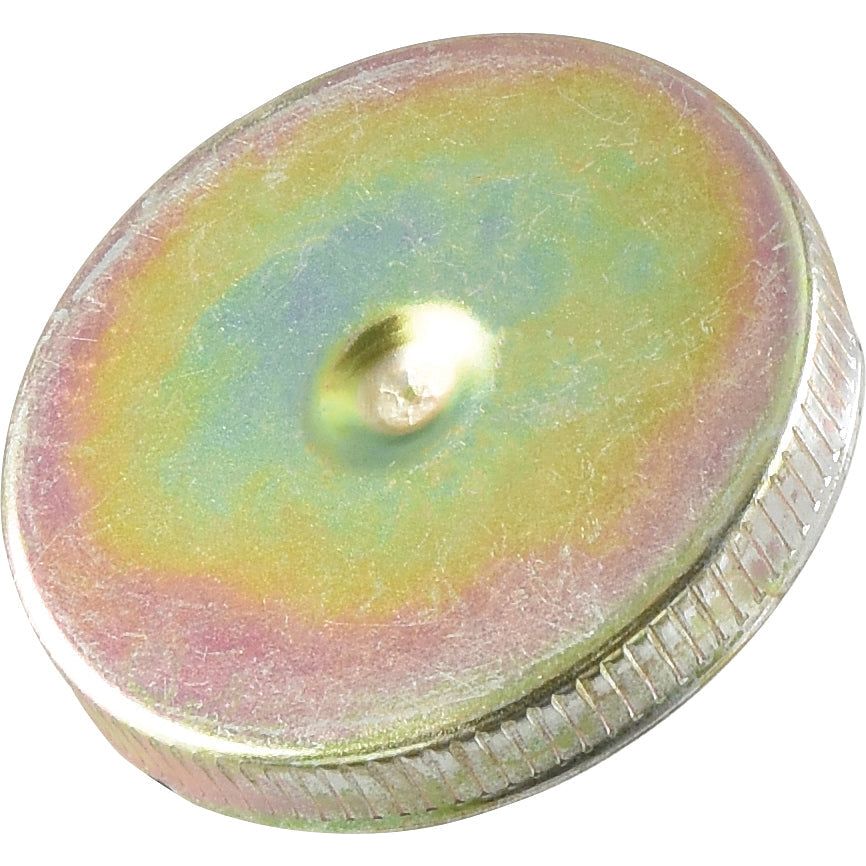 The Sparex Fuel Cap - S.40570 is a metallic disc with a green, yellow, and pink iridescent surface that features an intricate vented bayonet design.