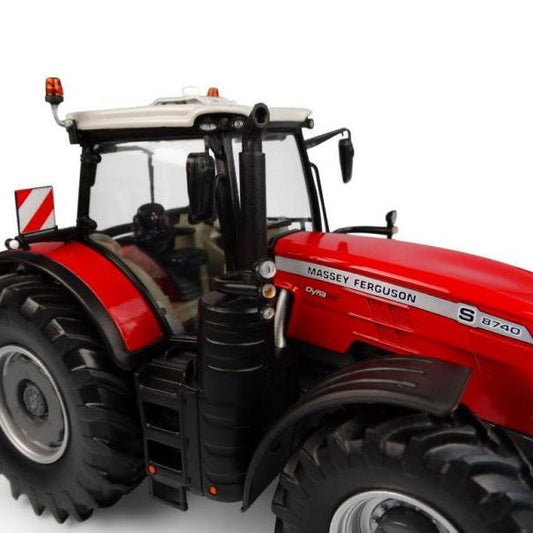 Close-up view of the detailed tires, chassis, and cabin interior of an AGCO Massey Ferguson - MF 8740S 2019 Version 1:32 - X993041906216 red model tractor.