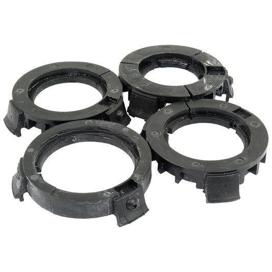 Four black plastic washer guides with grooves, distinctly arranged in a cluster on a white background, provide an efficient solution akin to Sparex PAK-PTO Bearings Eco-Small (Sparex Part No. S.10470).
