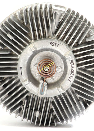 A close-up of the Sparex Viscous Fan Drive (Sparex Part No. S.104712), featuring a finned design with engraved arrows, numbers, and letters, reveals intricate components and details. This viscous fan drive is commonly found in Landini or Massey Ferguson tractors.