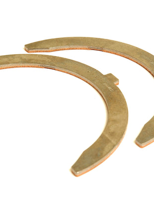 Image of Sparex Thrust Washers (Pair), Sparex Part No. S.110986, featuring semi-circular metal washers with flat inner edges and rounded outer edges, positioned parallel to each other, compatible with Sisu Engines.