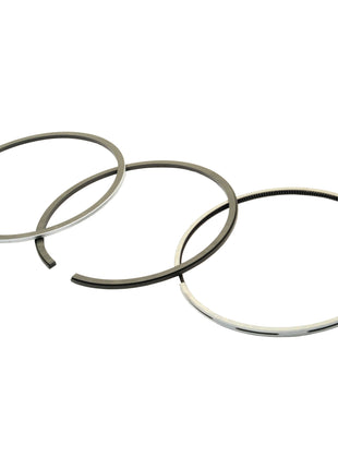 Three chrome-plated piston rings, each with slight variations in design and size, are arranged side by side. These Sparex Piston Rings (Sparex Part No. S.111804) are used for engines to provide a seal between the piston and the cylinder wall.