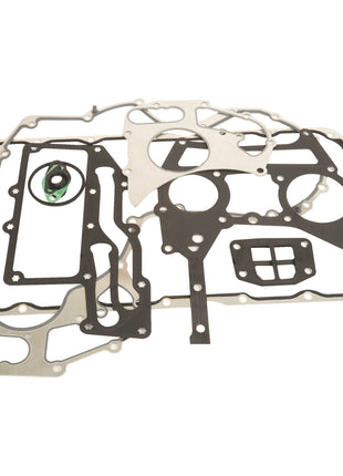 A collection of various metal and rubber engine gaskets, part of the Bottom Gasket Set - 4 Cyl. (Sparex Part No. S.111808) by Sparex, arranged flat on a white surface.