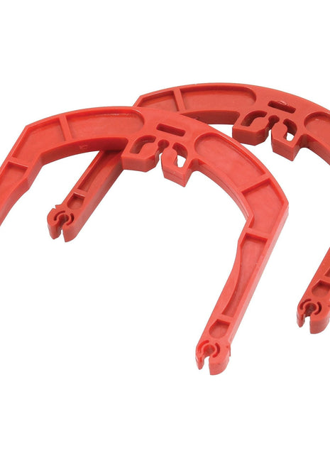 Two red plastic horseshoes with a geometric design, featuring a pair of large Replacement Gardloc C CLIPS (Sparex Part No. S.119982) from the Sparex brand, are placed side by side on a white background.