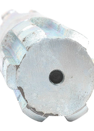 Close-up of a silver, cylindrical metal object with multiple flat protrusions around its circumference and a small circular depression in the center, resembling the design of a Sparex PTO Splined Shaft - Both Ends - 1 3/8'' - 6 Spline x 1 3/8'' - 6 Spline, Length: 300mm (Part No. S.15952).