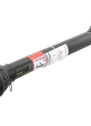 A black mechanical component tube with multiple attachments and warning labels, featuring the robust design of the Sparex PTO Shaft (Part Number: S.164294) - Length: 1010mm, 1 3/8'' x 6 spline quick release to 1 3/8'' x 6 spline friction disc clutch.