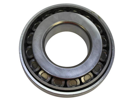 Close-up of the Sparex Taper Roller Bearing (4T-55200C/55437), featuring an inner and outer ring encasing cylindrical rollers; primarily used to reduce friction in rotating mechanical parts. Sparex Part Number: S.166839.