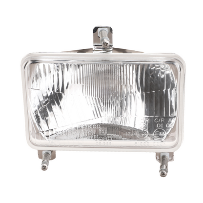 Rectangular headlight assembly with clear lens and metal mounting brackets, designed for Massey Ferguson 200 Series, by AGCO. Product Name: Massey Ferguson - Headlight - 1693943M93.