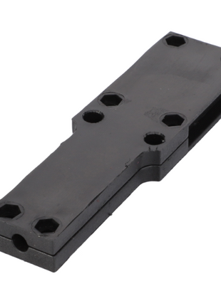 The AGCO Massey Ferguson - Housing - 1696854M2 is a black, rectangular metal or plastic component featuring six hexagonal screw holes and two indents on the longer sides, commonly used in Massey Ferguson 200 Series tractor parts.