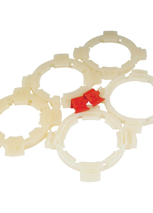 Six circular plastic parts, five beige and one red, arranged on a white background, reminiscent of a Sparex EASYLOCK BEARING PACK - LARGE (Sparex Part No. S.20537).