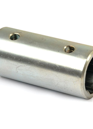 A cylindrical metal connector with two holes on its surface, used for joining components, often referred to as a PTO Splined Coupling - Female Spline 1 3/8'' - 6 with - S.27864 from Sparex.