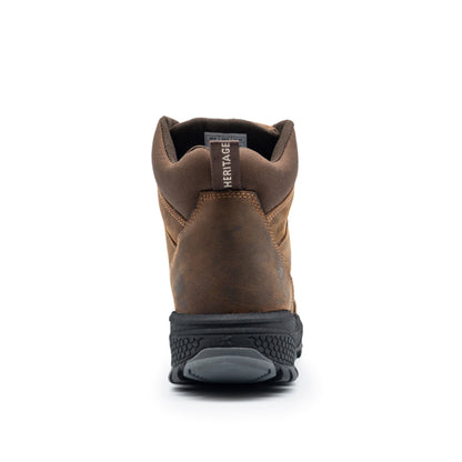 A rear view of the Cottonmount Xpert Heritage Explorer Waterproof Hiking Boot in brown, showcasing its black slip-resistant outsole and a "HERITAGE" tag on the back.