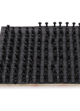 A Massey Ferguson mat by AGCO featuring multiple rows of evenly spaced small, black, rounded pegs.