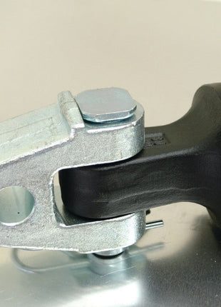 Close-up of a metal and rubber automotive part, specifically a Hydraulic Top Link (Cat.3/3) Knuckle and Q.R CBM Hook from Sparex, placed on a reflective surface—suitable for tractors.