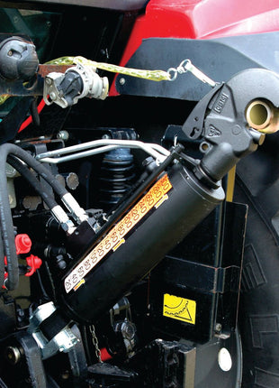 Close-up of hydraulic and mechanical components attached to a tractor, featuring pipes, cables, and control mechanisms in a partly red and black machine. The intricate setup includes the Hydraulic Top Link (Cat.3/3) Knuckle and Q.R CBM Hook from Sparex, with a 90mm cylinder bore, ensuring efficient operation of the implement at the end.