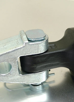 Close-up of a Sparex Hydraulic Top Link (Cat.3/3) with a knuckle and quick-release CBM hook, featuring an 80mm cylinder bore and a minimum length of 610mm, showcasing its U-shaped bracket and bolt fitting into a black cylindrical part on a reflective surface, evocative of components used in tractor hydraulic cylinders. (Sparex Part No. S.399811)