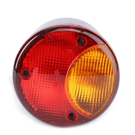 A round, two-tone vehicle tail light with red and amber sections, secured by four black screws, perfect for the Massey Ferguson 6400 Series, is available as the AGCO Massey Ferguson Rear Light L/H - 4295458M2.