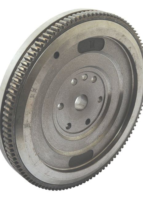 Close-up of the Flywheel Assembly 13'' (Sparex Part No.S.43788) from Sparex, featuring gear teeth and circular patterns with center holes for attachment, reminiscent of components found in classic Landini tractors.