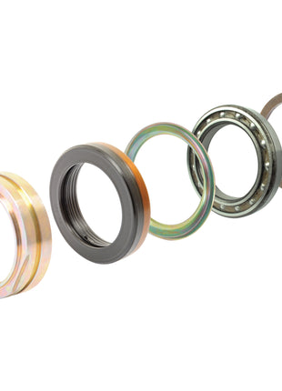 A mechanical assembly in the Seal Kit (PTO - Single Speed) | Sparex Part No. S.43931 from Sparex features five circular components arranged in sequence: a brass-colored ring, a black ring with inner threading, a greenish Sparex disc, a ball bearing, and a metal retainer clip.