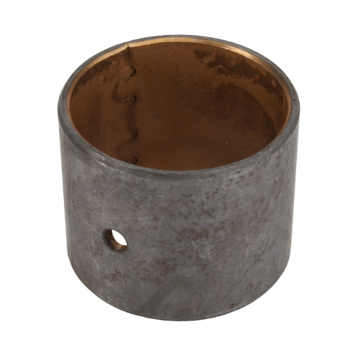 A cylindrical metal bearing with an open center and a small hole on its side, featuring a worn, slightly discolored exterior surface, is often identified as the Massey Ferguson - Bush Conrod - 744971M1 from the AGCO brand. This part is commonly found among Massey Ferguson tractor parts from the 1000 Series.