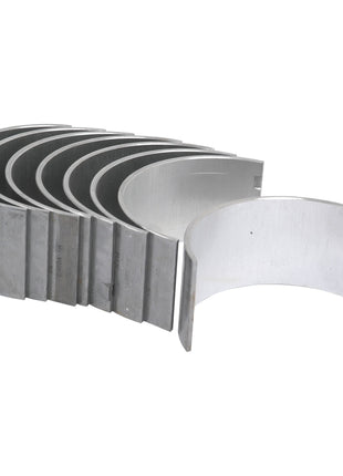 The Conrod Bearing Std. Set by Sparex (Sparex Part No.S.42922) is a set of seven metallic semi-circular bearing shells arranged in a staggered stack, designed to be compatible with Landini, Massey Ferguson, and Perkins engines.