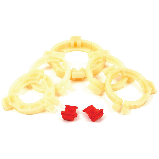 Five beige plastic rings arranged in a semi-circle with two small Easylock Bearing Pack (Sparex Part No. S.20536) Medium clips in red placed in front of them.