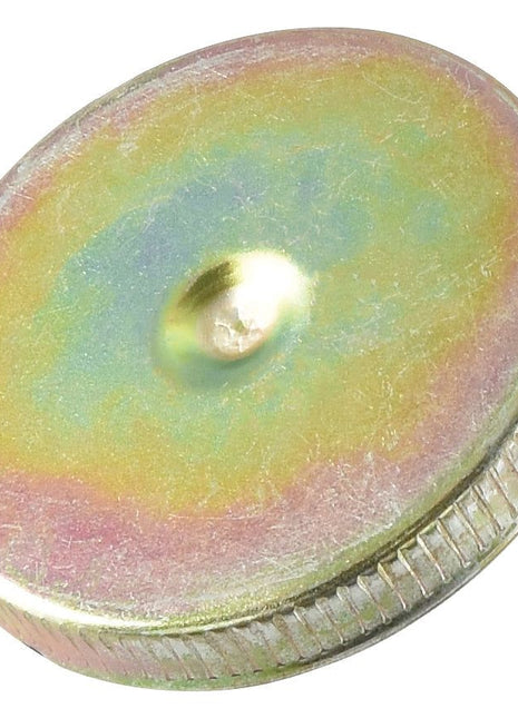 The Sparex Fuel Cap - S.40570 is a metallic disc with a green, yellow, and pink iridescent surface that features an intricate vented bayonet design.