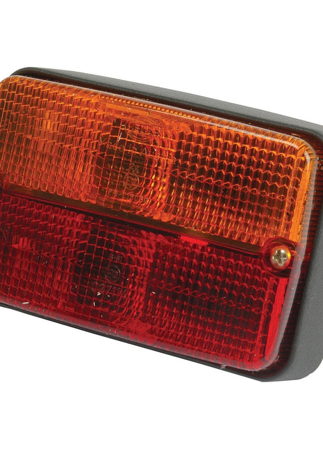 A Sparex Rear Combination Light (Halogen), 12V - S.41400, featuring an amber upper section and a red lower section, crafted from durable polycarbonate for longevity. This versatile Brake/Tail/Indicator ensures excellent visibility on the road and is suitable for both right-hand and left-hand applications.