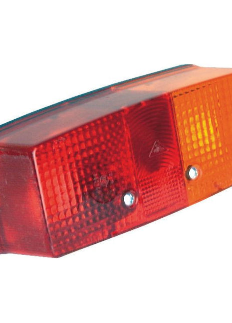 A rectangular vehicle tail light with a red and orange lens, featuring a textured surface and two visible screws, compliant with E Approved standards is known as the Rear Combination Light (Halogen) by Sparex. It functions as a brake, tail, and indicator light for the right-hand side, suitable for 12/24V - S.56106.