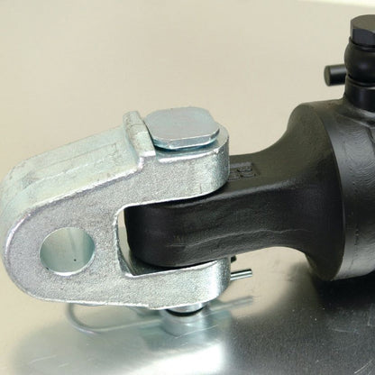 Close-up of a Sparex Hydraulic Top Link (Cat.28mm/3) Knuckle and Q.R CBM Hook, featuring an 80mm cylinder bore and resting on a reflective surface, showcasing its heavy-duty mechanical joint with hinge and clamp components.