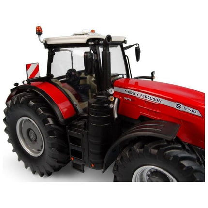 Close-up view of the detailed tires, chassis, and cabin interior of an AGCO Massey Ferguson - MF 8740S 2019 Version 1:32 - X993041906216 red model tractor.