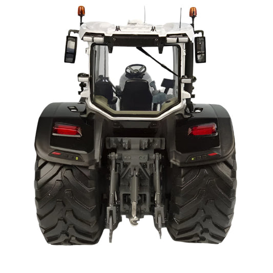 Rear view of a 1:32 scale model MF 8S.285 Black Version tractor (X993042106341) by AGCO, showcasing large tires, rear lights, and hydraulic arms. The Massey Ferguson tractor features a cab with a steering wheel and mirrors. The background is plain and neutral.