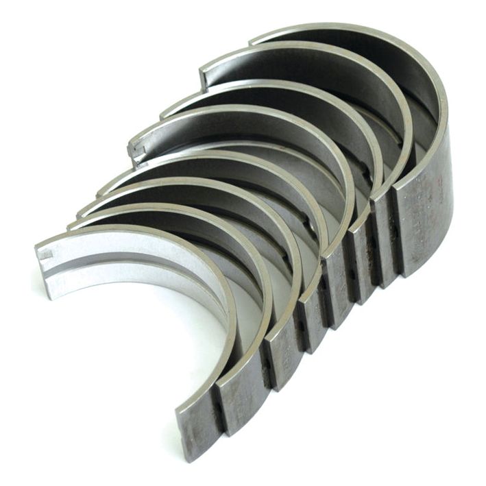 A set of eight Main Bearings +0.040'' (1mm) (Sparex Part No.S.42077), perfect for Perkins or Massey Ferguson models, arranged in an overlapping semi-circular stack from Sparex.