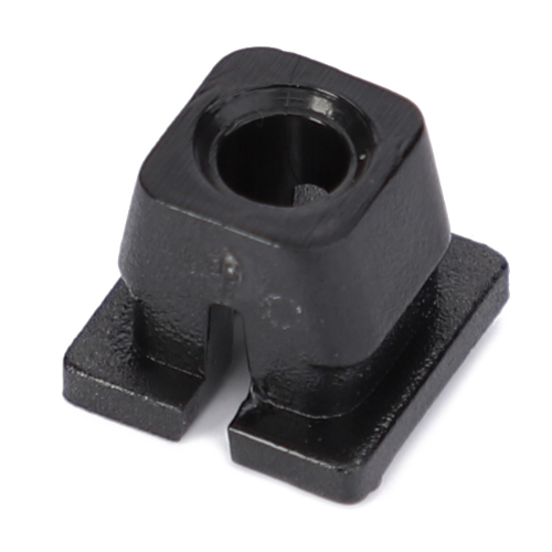 Close-up of the AGCO Massey Ferguson - Nut Cladding - 3809347M1, a small, black, square-shaped object with a circular hole in the center and a slot on one side, possibly used as a mounting bracket or hardware component for the Massey Ferguson 4200 Series tractor parts.