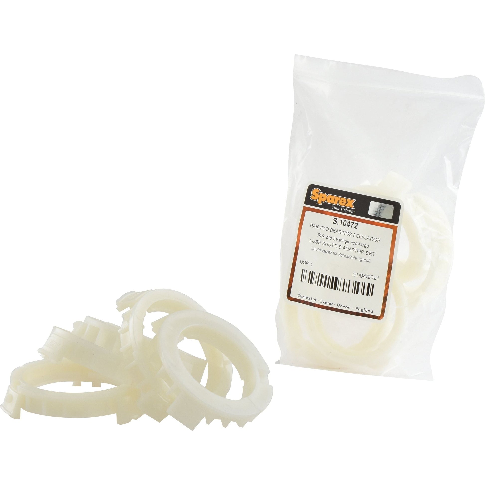 A set of white plastic parts, with some loose on the surface and others in a clear plastic package labeled "PAK-PTO Bearings ECO-Large | Sparex Part No. S.10472".