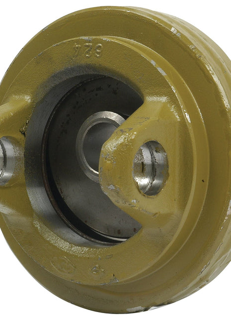 Close-up image of a yellow metal mechanical part with a circular shape, two bolt holes, and an internal wheel, resembling specifications found in the Sparex PTO Wide Angle Centre Body (U/J Size: 32 x 76 & 27 x 94mm) | Sparex Part No.S.6665 by Sparex.