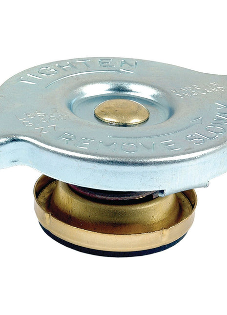 Introducing the Radiator Cap - S.8453 by Sparex, a silver cap featuring engraved instructions to tighten or remove slowly. It boasts a round, central top section and includes a rubber seal at the bottom. Designed with an optimal width for compatibility, it efficiently maintains pressure.