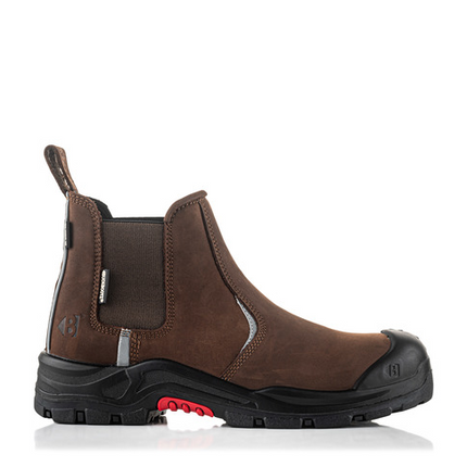 The Buckler Nubuckz Safety Dealer Boot (Nkz101Br) is a brown leather slip-on work boot featuring a black slip-resistant rubber sole and toe cap with red accents. This piece of safety footwear from Buckler ensures both durability and style.