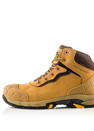 The Buckler - Tradez Blitz Waterproof Safety Boot in tan and black, featuring a textured rubber sole, reinforced toe and heel areas for added durability and safety, metal-free toe protection, and laces.