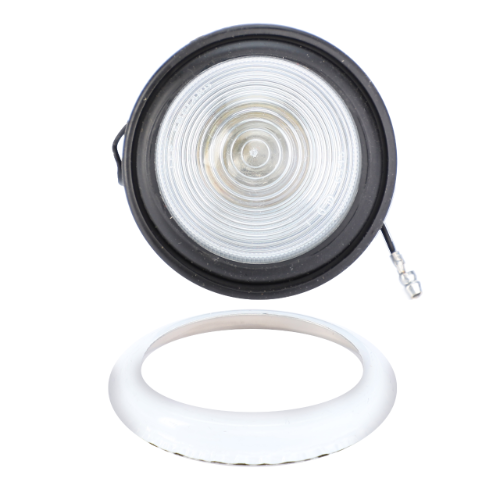 AGCO's Massey Ferguson Sidelight, part number 880399M2, is a circular light fixture with a clear lens and black rim. It is designed for the Massey Ferguson 135 tractor and includes a separate white circular frame with a small metal connector attached to the lens housing.