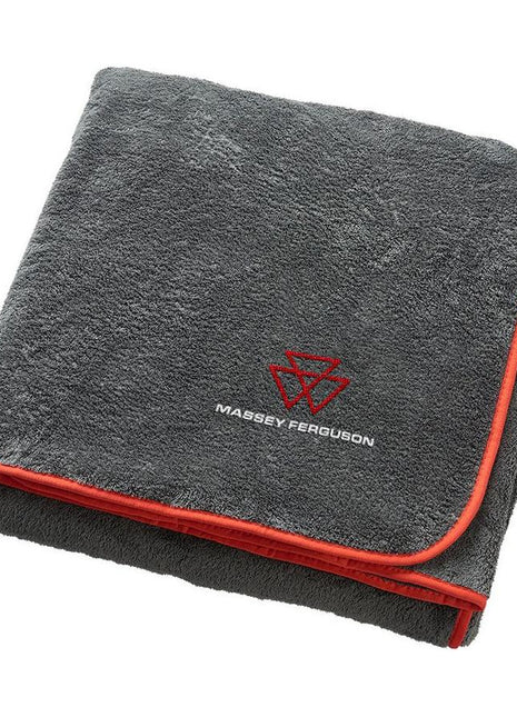 A folded AGCO Massey Ferguson - New Logo Blanket (X993412005000) in grey fleece-feel with red trim and the Massey-Ferguson logo embroidered on it.