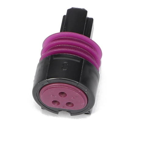 The AGCO | Socket Terminal - AG522498 from the brand AGCO is an electrical connector plug with a black casing and a purple seal, featuring three circular holes for connections.