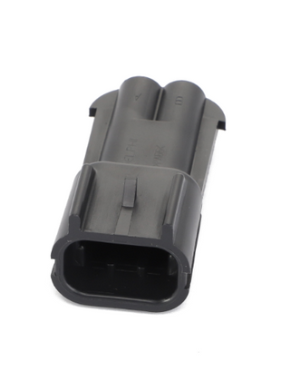 The AGCO | PLUG CONNECTOR - AG517616 is a black rectangular electrical connector designed with grooves and indents for secure fitting.