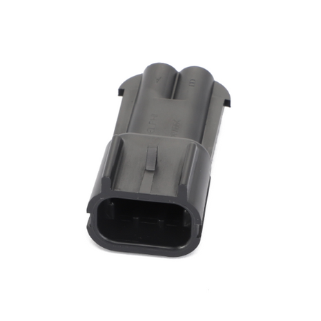 The AGCO | PLUG CONNECTOR - AG517616 is a black rectangular electrical connector designed with grooves and indents for secure fitting.