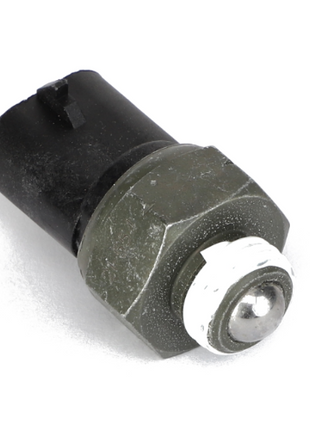 Close-up image of the AGCO NEUTRAL START SWITCH - AG133277, a small cylindrical electronic component with a black plastic top, metallic hexagonal middle, and silver rounded end.