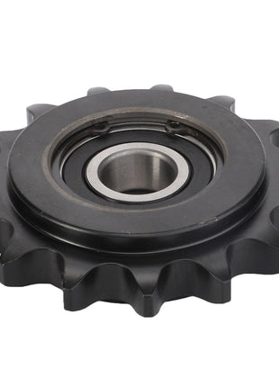 Close-up of the AGCO TENSIONER PULLEY - ACY1560850, a black metal spur gear with a central bearing and evenly spaced teeth around its circumference. No product description needed for appreciating its precise engineering.