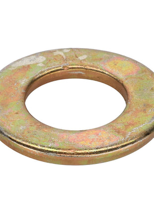 A flat, round metal washer with a central hole, showing signs of wear and a tarnished surface, reminiscent of the enduring reliability found in vintage Massey Ferguson MF 135 tractors, much like the AGCO | FLAT WASHER - AG561156.