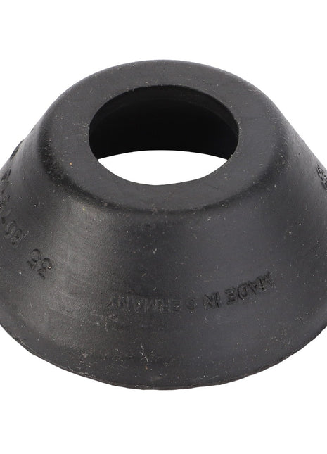 The AGCO Sealing Cap (model F184300020220) is a black rubber grommet that includes a central hole, beveled edges, and a slight conical shape. While there is no detailed product description currently available, text can be found inscribed around its outer surface.